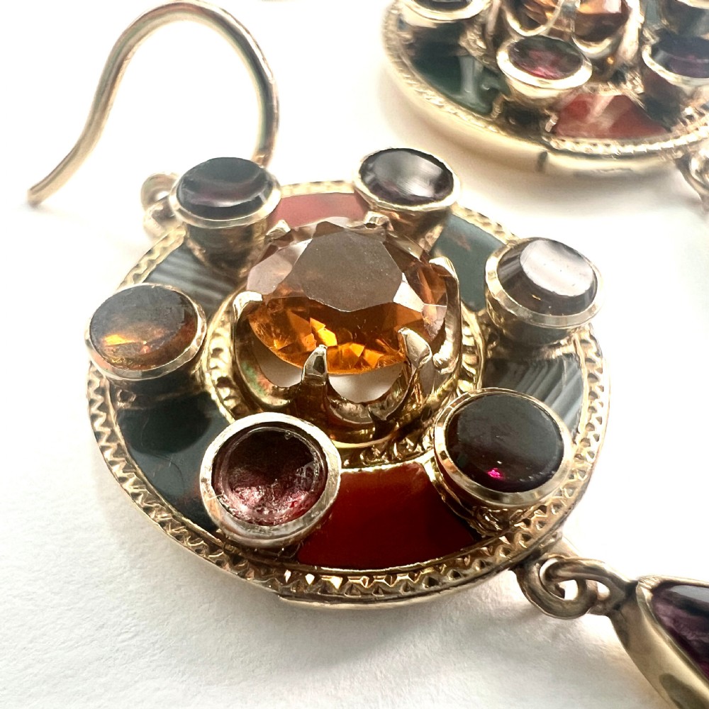 A pair of Victorian 9ct gold target drop earrings inlaid with patterned agates and surrounding central citrine gemstones. View IV