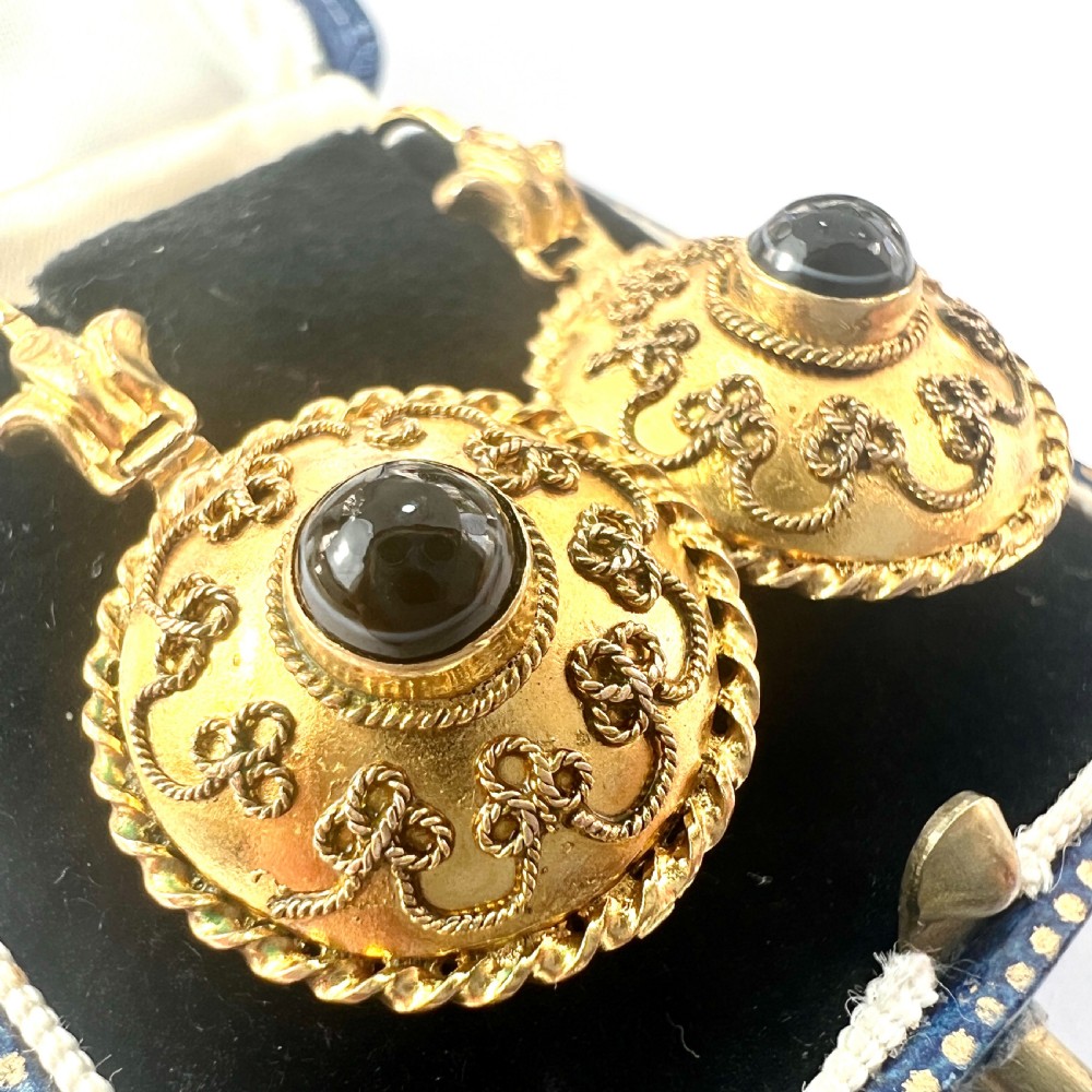 A pair of circular Victorian 15ct gold domed drop earrings featuring detailed scroll wirework, rope twist borders, and central dark agate cabochons. View II