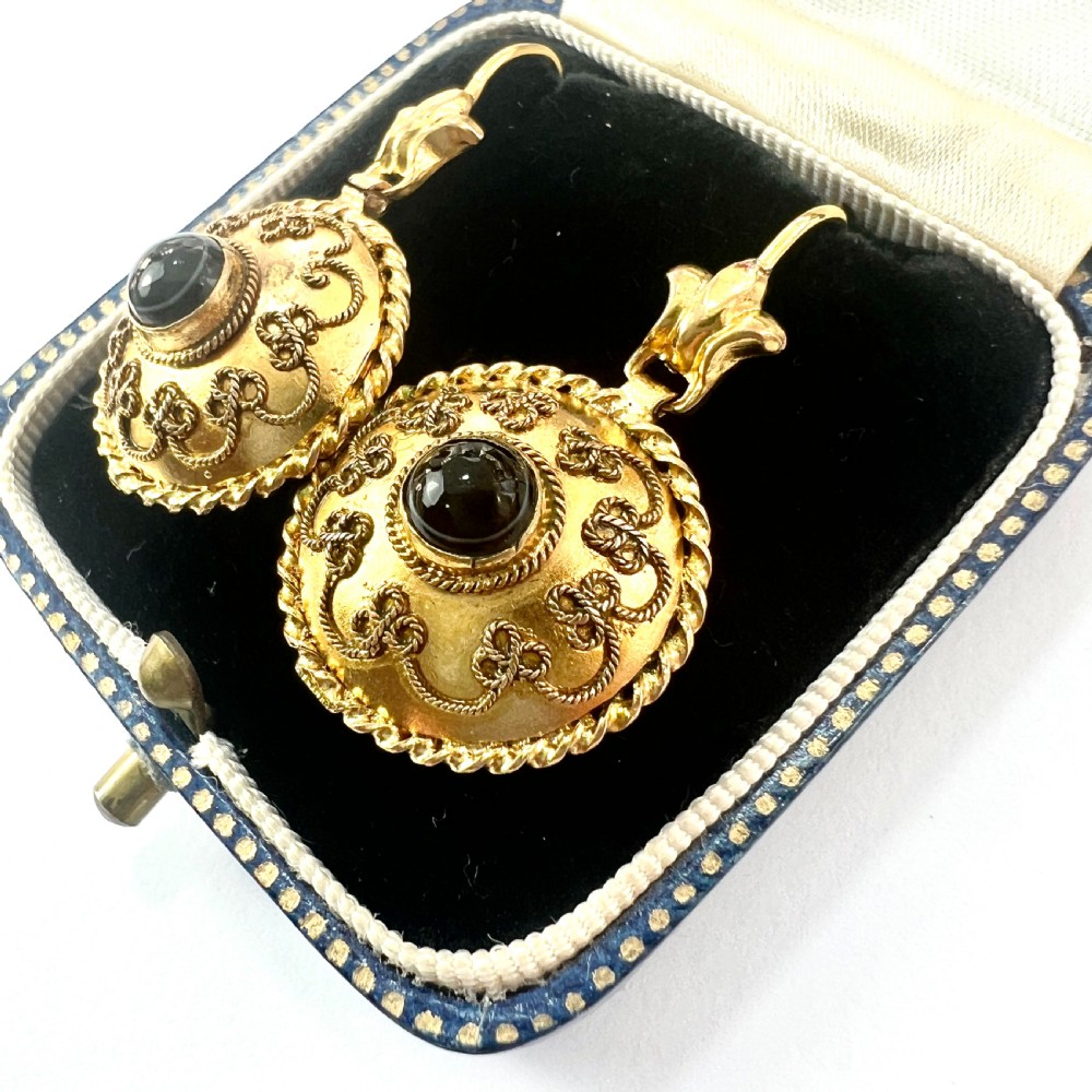 A pair of circular Victorian 15ct gold domed drop earrings featuring detailed scroll wirework, rope twist borders, and central dark agate cabochons. View III