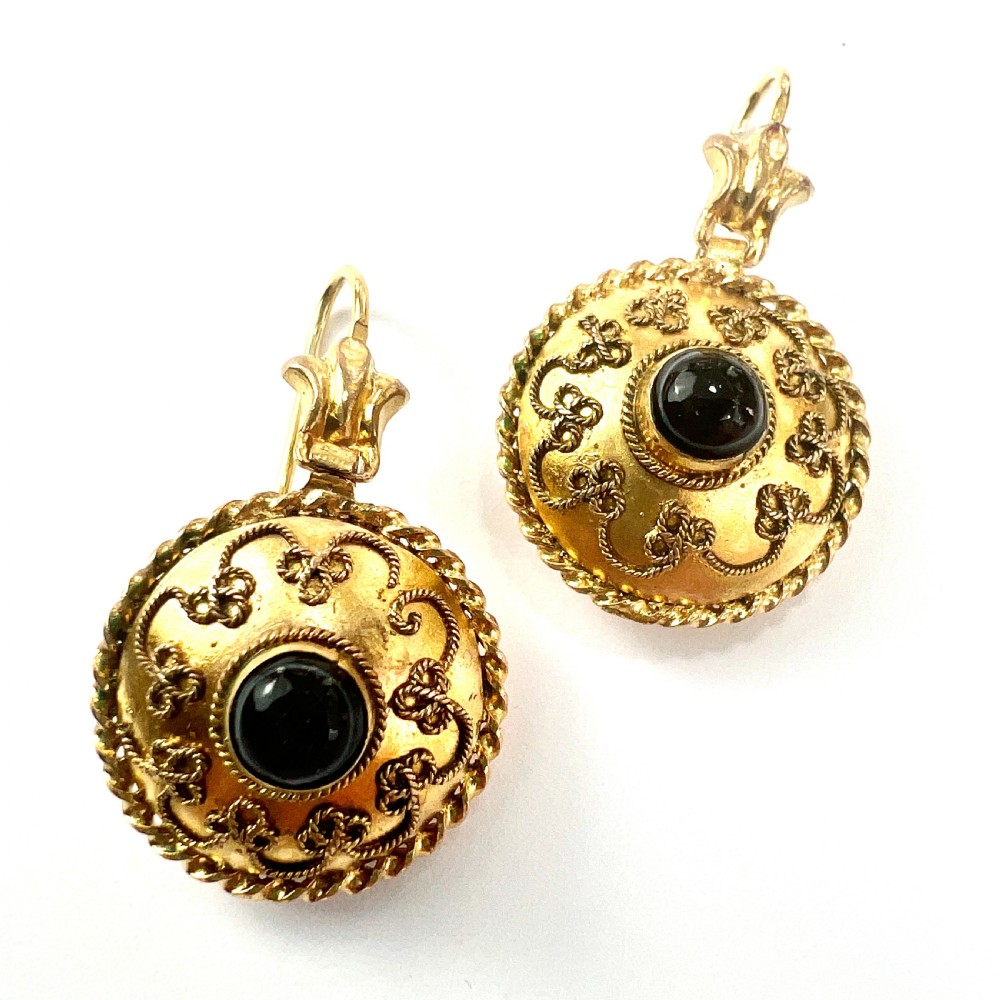 A pair of circular Victorian 15ct gold domed drop earrings featuring detailed scroll wirework, rope twist borders, and central dark agate cabochons. View VI