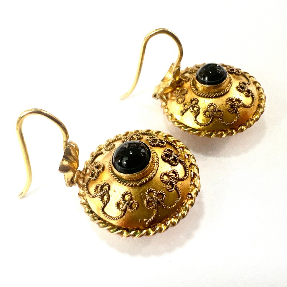A pair of circular Victorian 15ct gold domed drop earrings featuring detailed scroll wirework, rope twist borders, and central dark agate cabochons. View VIII