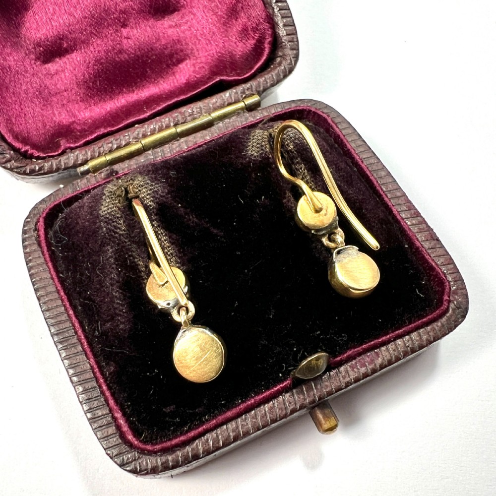 A pair of Victorian gold drop earrings with pearl accents and turquoise cabochons, resting inside a velvet presentation box. View V