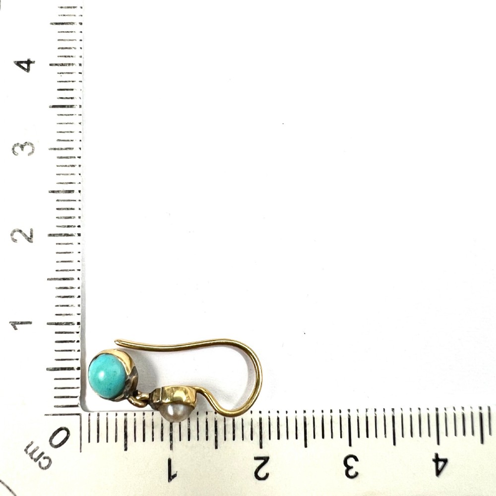 A pair of Victorian gold drop earrings with pearl accents and turquoise cabochons, resting inside a velvet presentation box. View VI