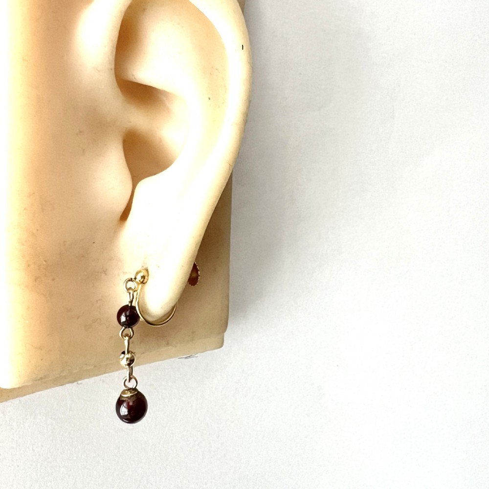 Pair of Edwardian 9ct yellow gold drop earrings with linked chains, spherical gold spacers, and polished dark red garnet beads on screw-back fittings. View VIII