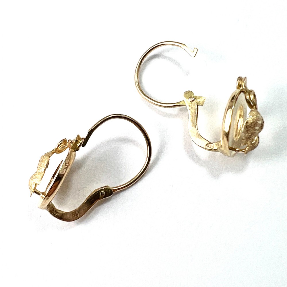 A pair of Victorian 18ct yellow gold circular disc dormeuse earrings featuring chased relief vine leaf motifs. View VI