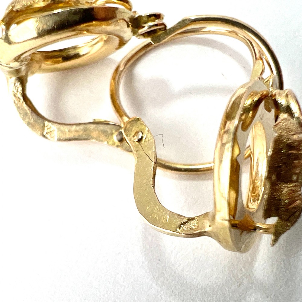 A pair of Victorian 18ct yellow gold circular disc dormeuse earrings featuring chased relief vine leaf motifs. View VII