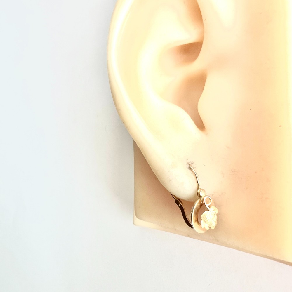 A pair of Victorian 18ct yellow gold circular disc dormeuse earrings featuring chased relief vine leaf motifs. View IX