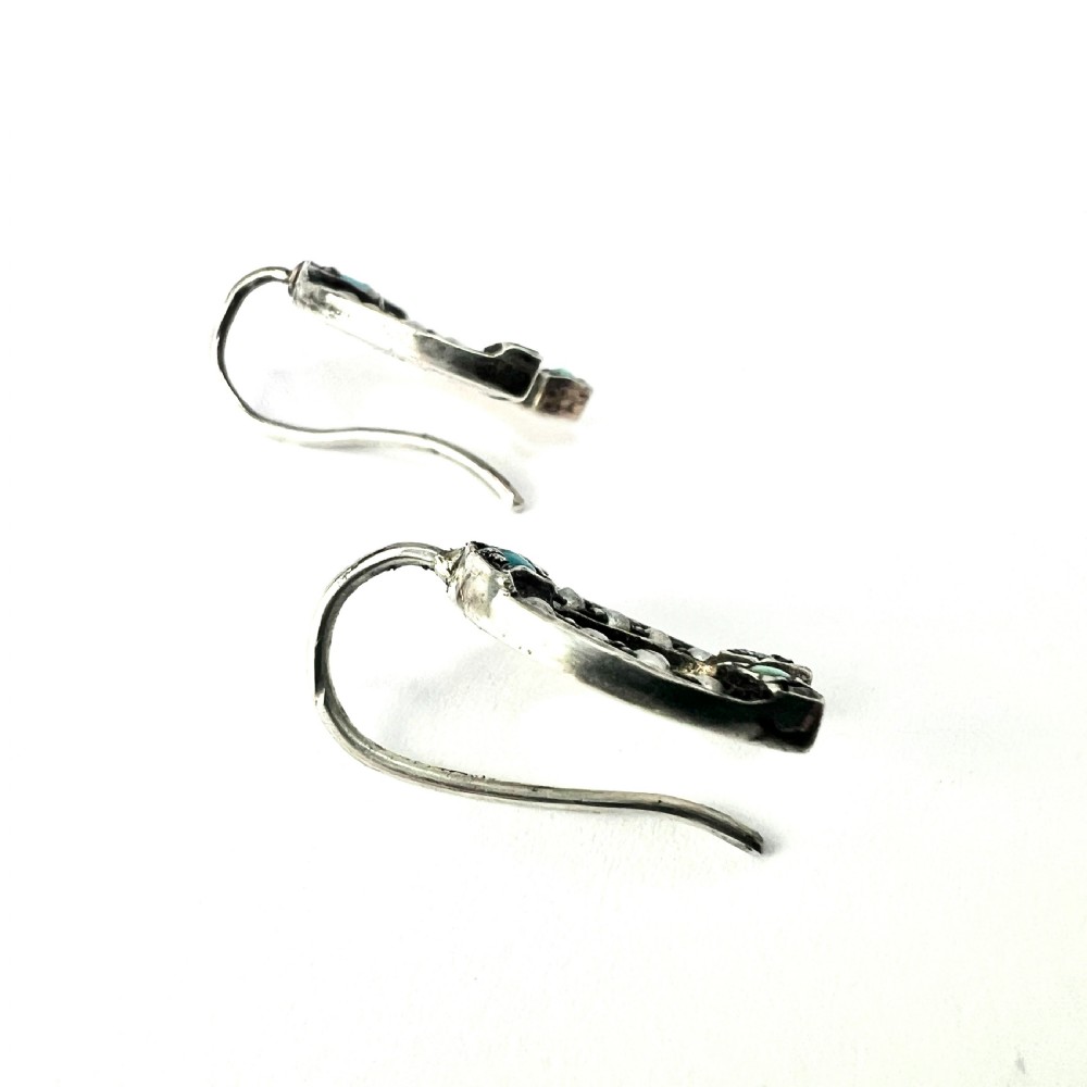 A pair of Victorian sterling silver horseshoe drop earrings set with turquoise cabochons and split seed pearls inside a velvet case. View V