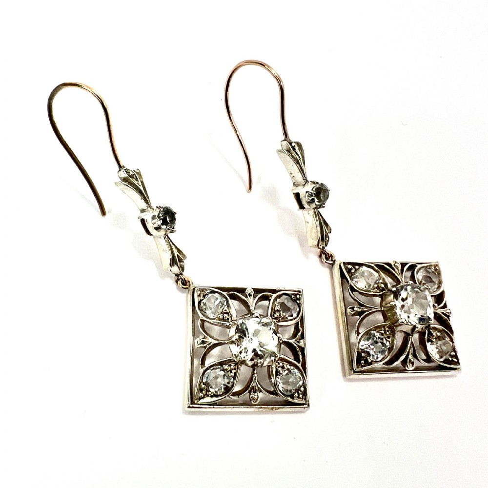 A pair of Victorian silver and 9ct gold drop earrings featuring diamond-shaped filigree openwork set with clear faceted rock crystals. View III
