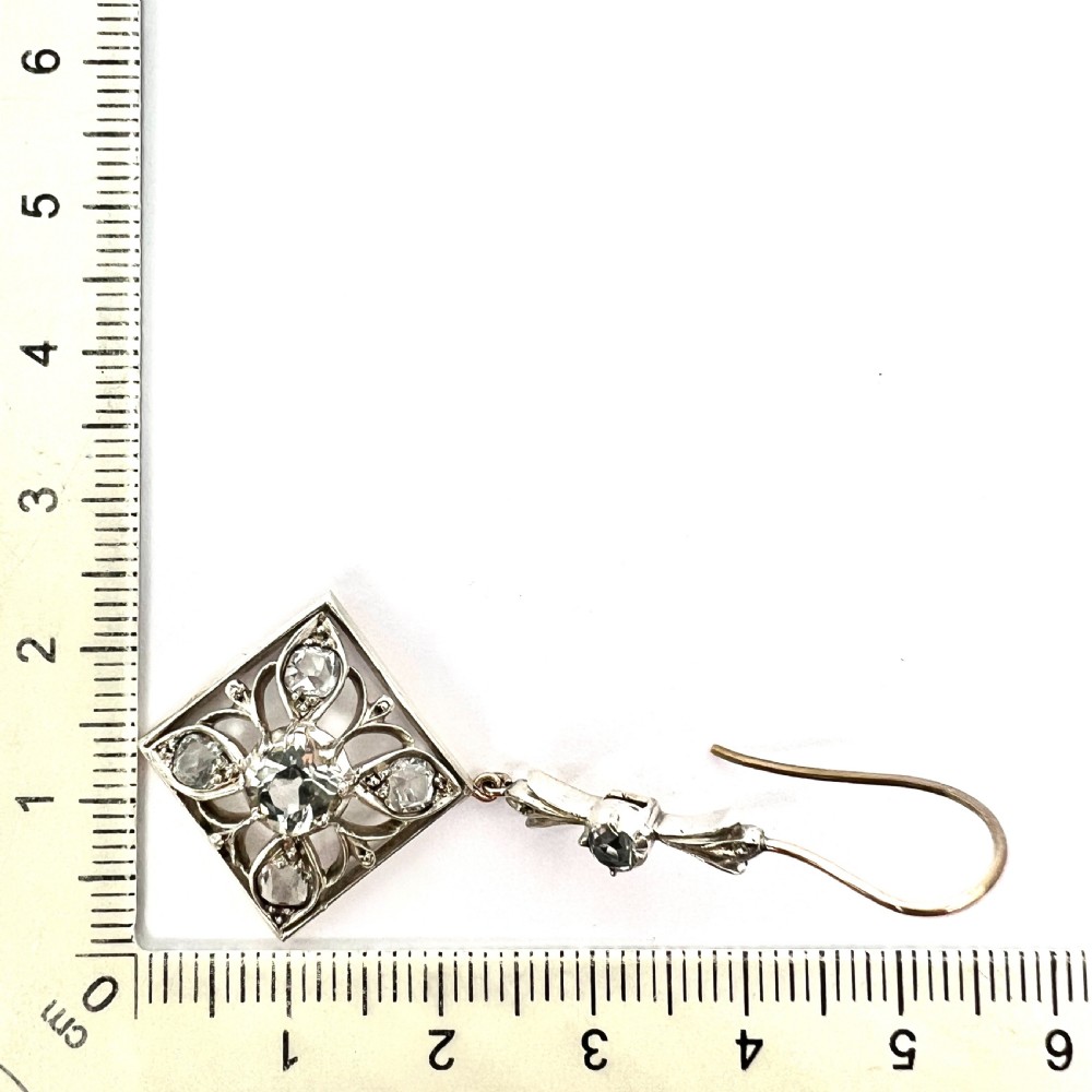 A pair of Victorian silver and 9ct gold drop earrings featuring diamond-shaped filigree openwork set with clear faceted rock crystals. View VI