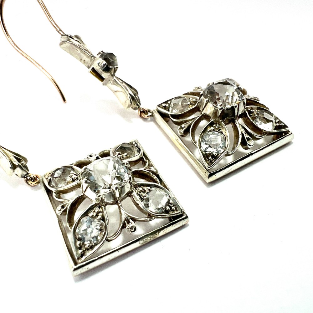 A pair of Victorian silver and 9ct gold drop earrings featuring diamond-shaped filigree openwork set with clear faceted rock crystals. View VIII