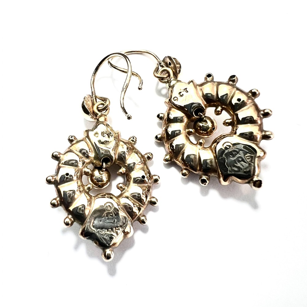 A pair of Victorian 9ct yellow gold drop earrings featuring circular wheel-like motifs with central spherical beads suspended from wire hooks. View VII