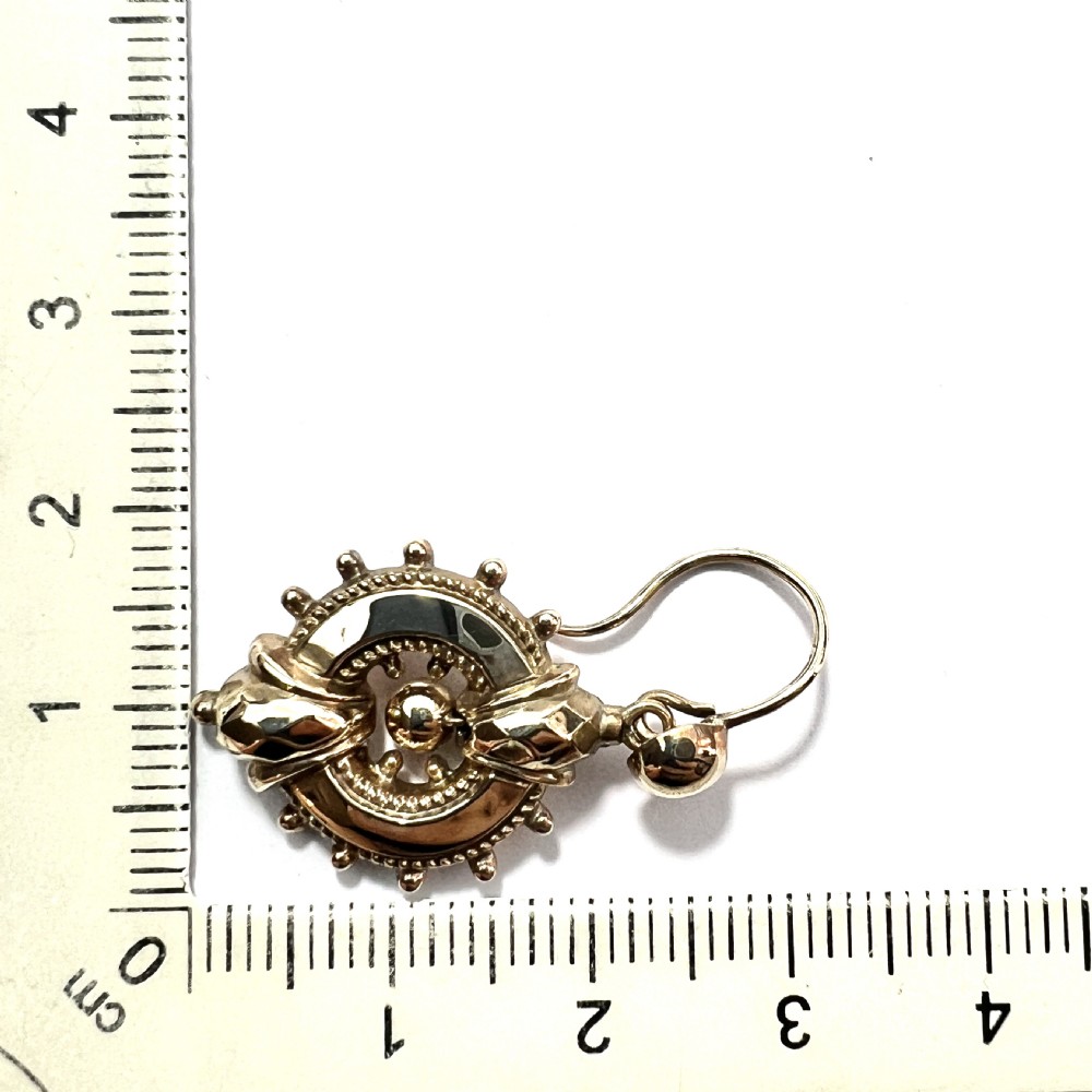 A pair of Victorian 9ct yellow gold drop earrings featuring circular wheel-like motifs with central spherical beads suspended from wire hooks. View IX