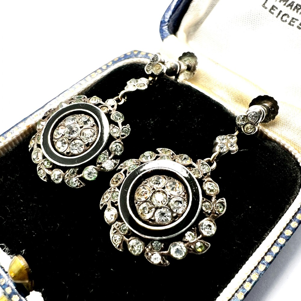 A pair of antique silver drop earrings featuring black enamel concentric rings, pave paste glass centres, and screwback fittings. View II