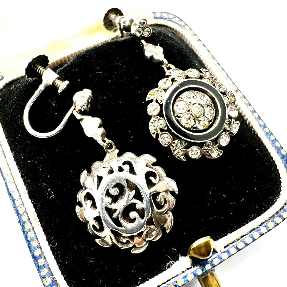 A pair of antique silver drop earrings featuring black enamel concentric rings, pave paste glass centres, and screwback fittings. View III