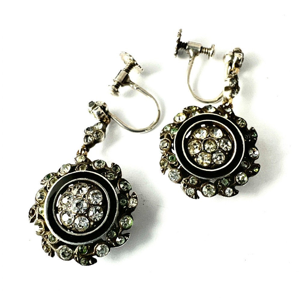 A pair of antique silver drop earrings featuring black enamel concentric rings, pave paste glass centres, and screwback fittings. View VI