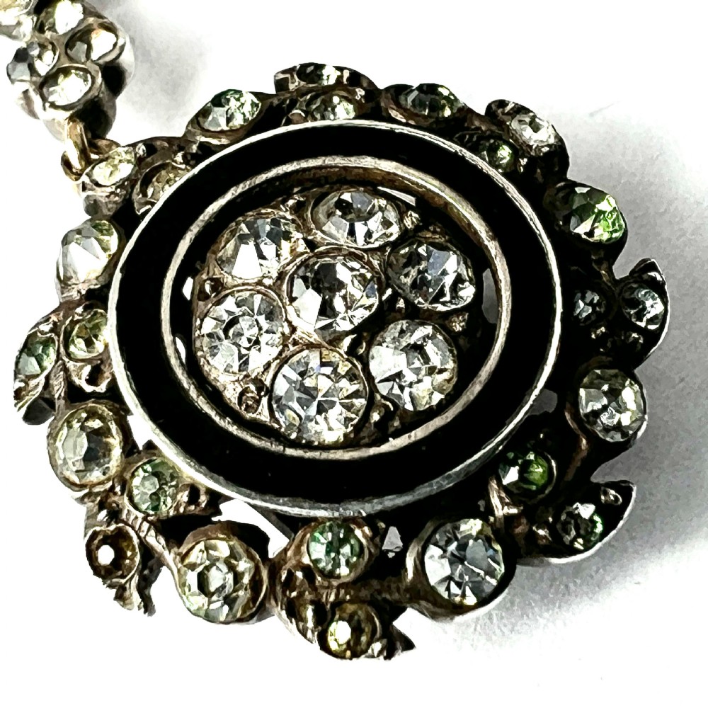 A pair of antique silver drop earrings featuring black enamel concentric rings, pave paste glass centres, and screwback fittings. View VII