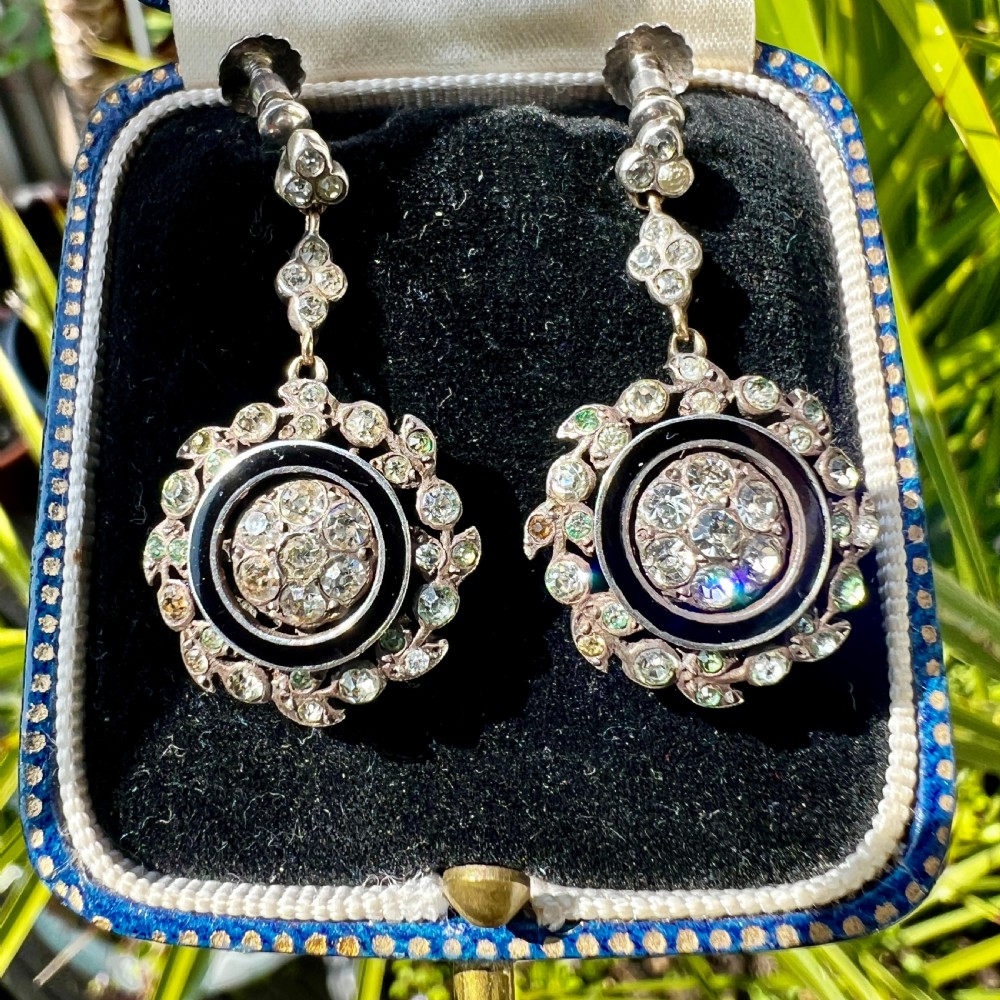 A pair of antique silver drop earrings featuring black enamel concentric rings, pave paste glass centres, and screwback fittings. View VIII