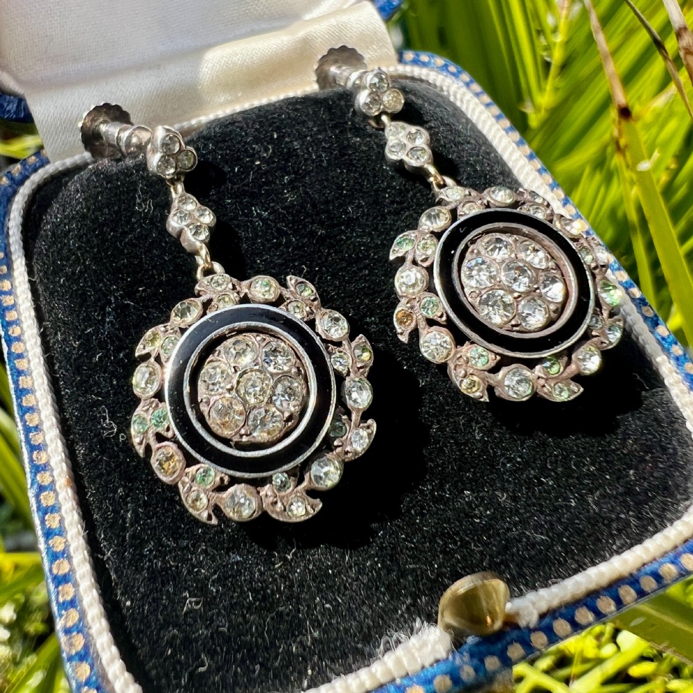 A pair of antique silver drop earrings featuring black enamel concentric rings, pave paste glass centres, and screwback fittings. View IX