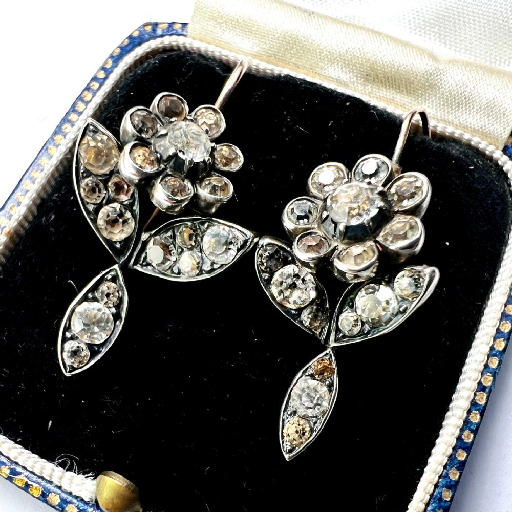 A pair of Georgian floral drop earrings featuring closed-back foil-set clear paste stones with black dots set in silver with gold fittings. View II