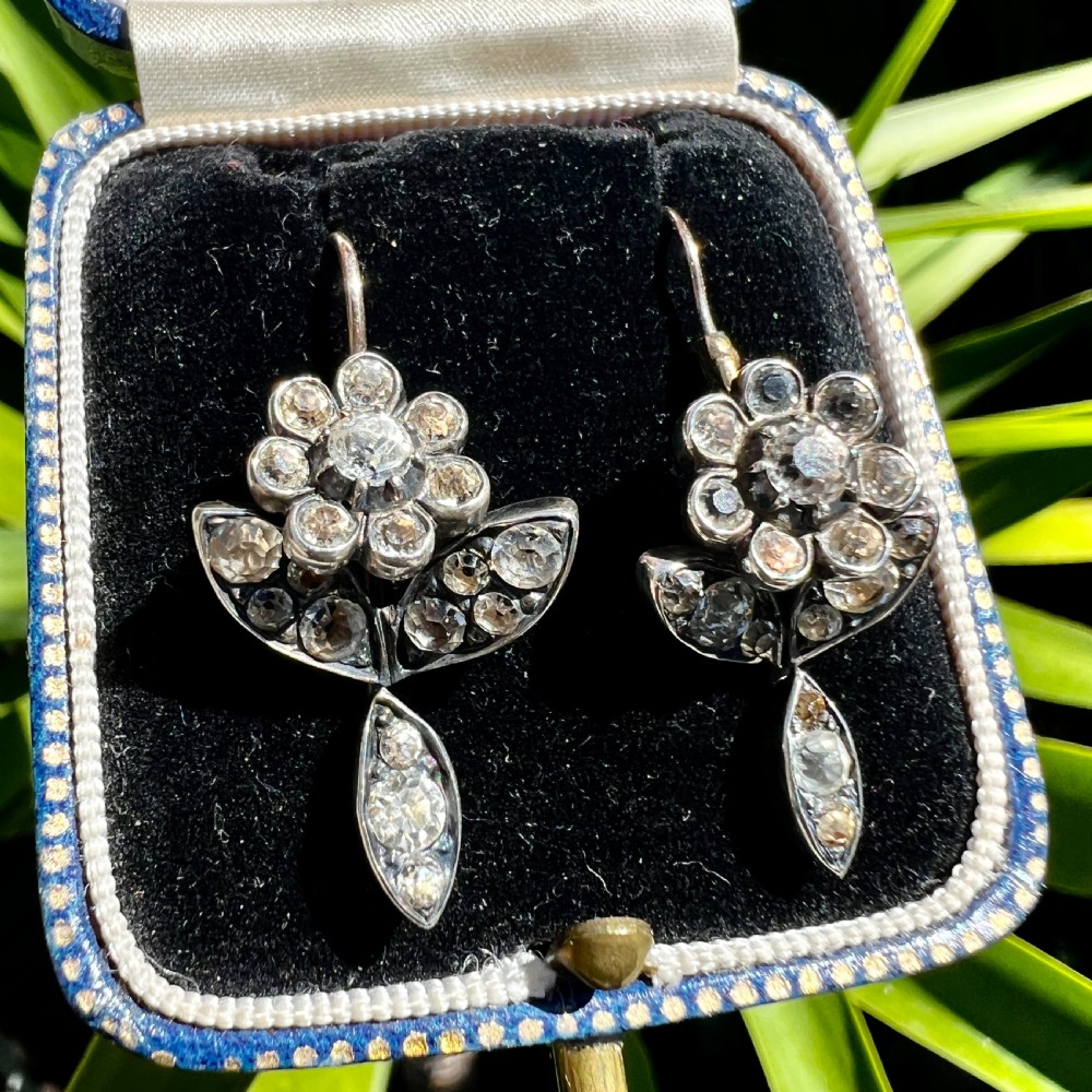 A pair of Georgian floral drop earrings featuring closed-back foil-set clear paste stones with black dots set in silver with gold fittings. View VIII