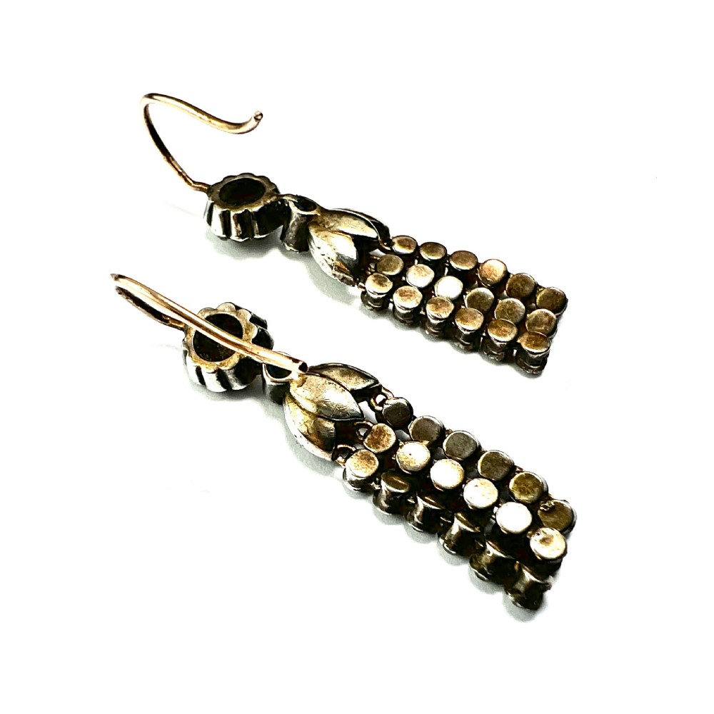 A pair of Victorian silver and gold drop earrings featuring floral cluster tops and articulated paste tassel strands set with clear stones. View V