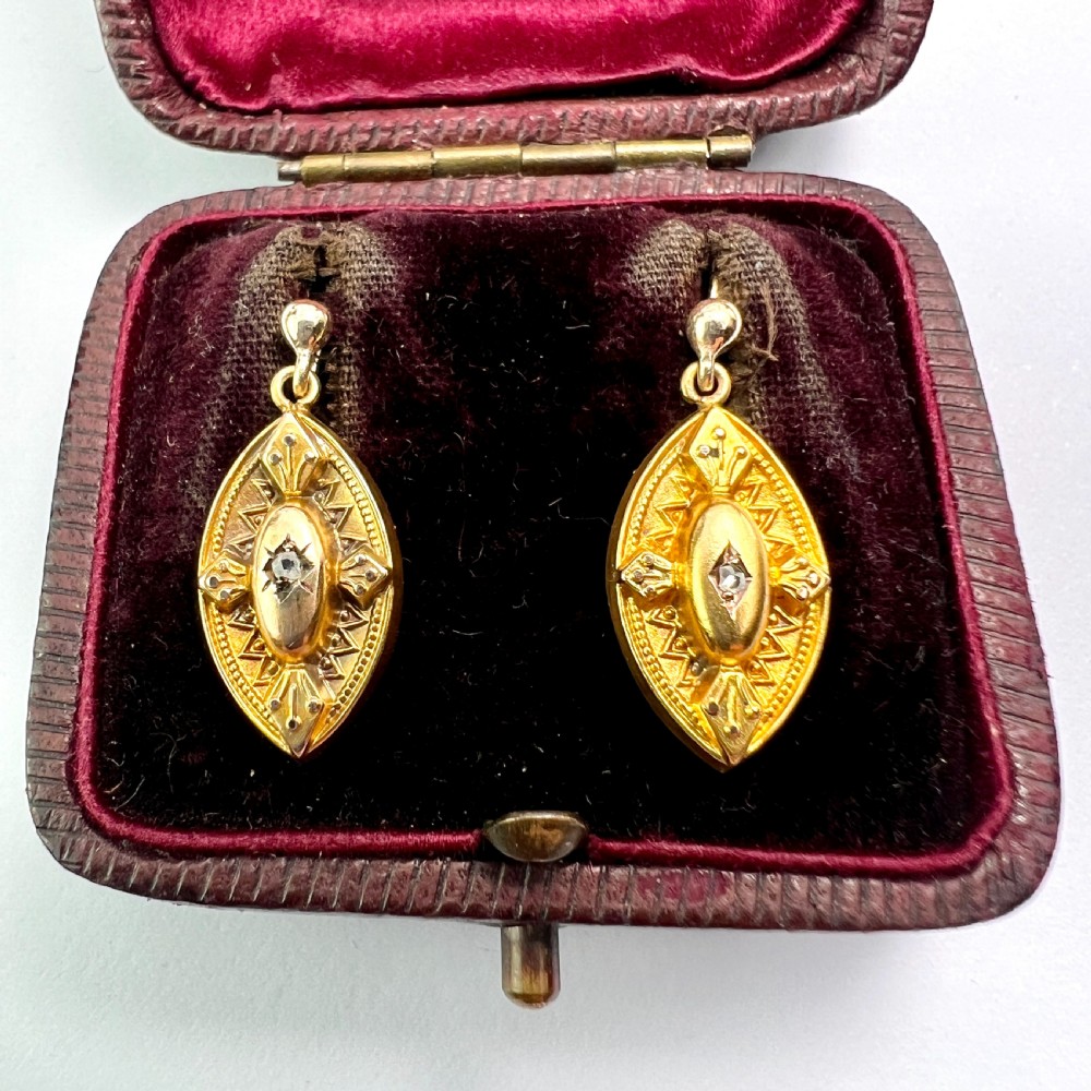 A pair of Victorian 9ct yellow gold marquise-shaped drop earrings featuring star-set diamond centres and engraved geometric detail. View II