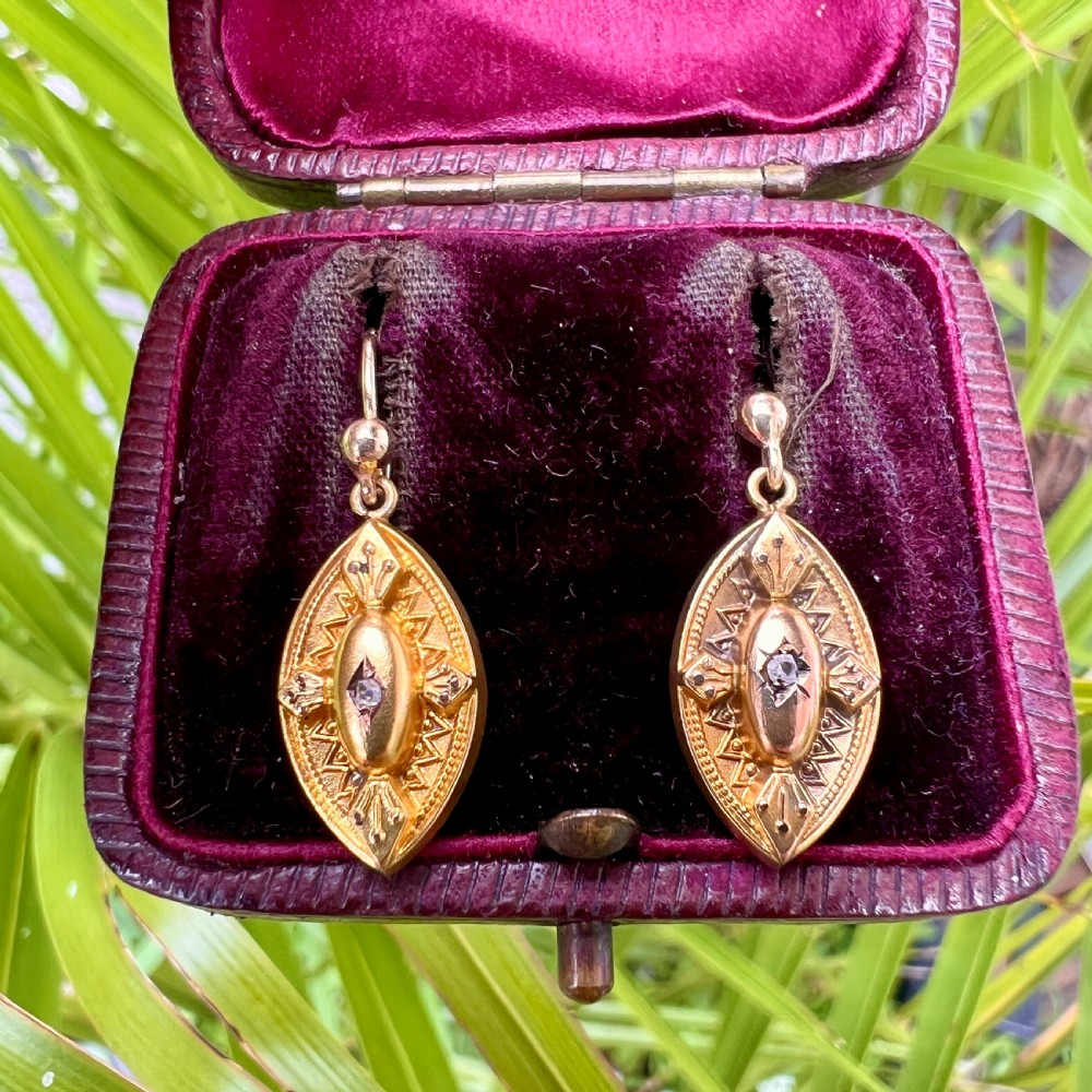 A pair of Victorian 9ct yellow gold marquise-shaped drop earrings featuring star-set diamond centres and engraved geometric detail. View VIII
