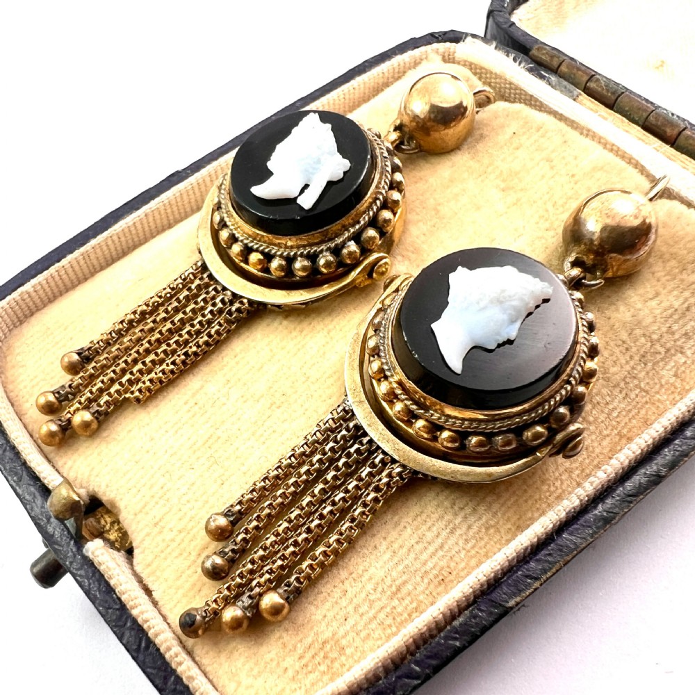 A pair of Victorian gold drop earrings featuring carved classical profile cameos mounted on black discs with cascading foxtail chain tassels. View III