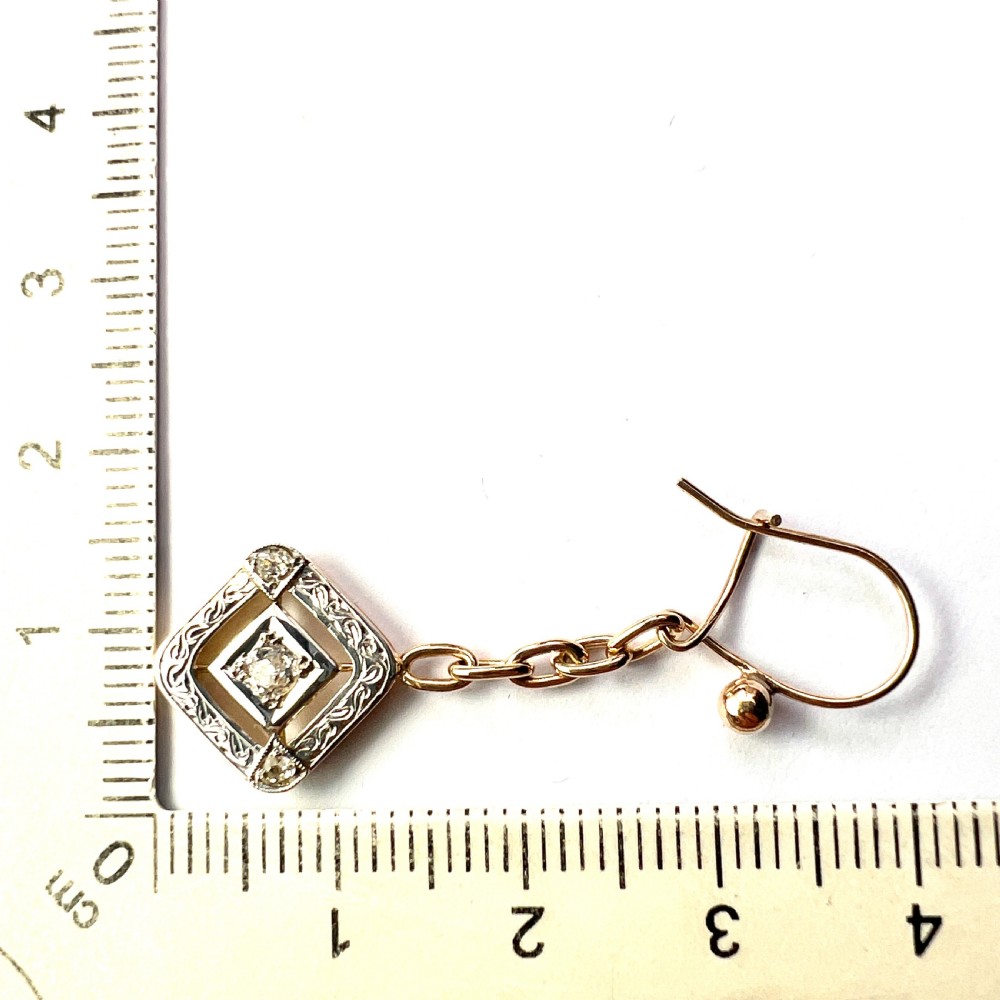 A pair of Edwardian style diamond drop earrings crafted in yellow and white gold with diamond-shaped engraved pendants. View VIII