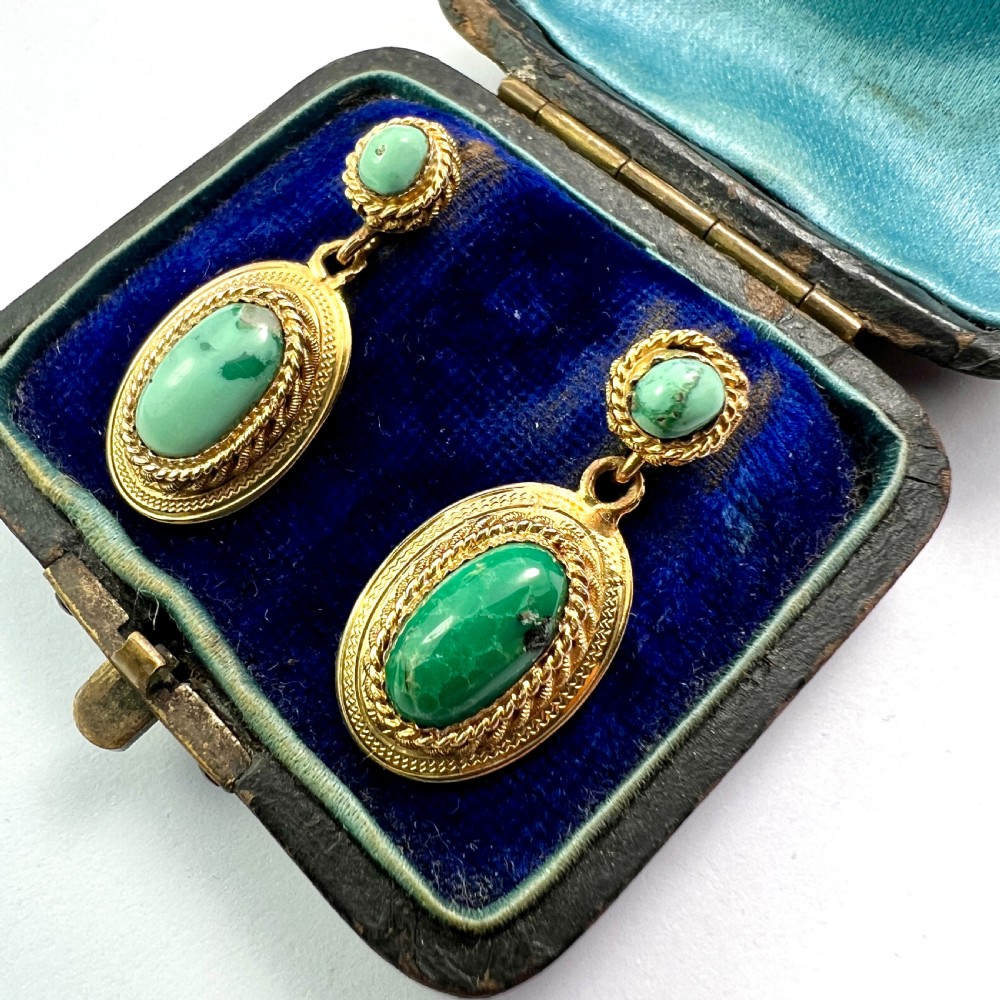 A pair of Etruscan Revival drop earrings in yellow gold featuring oval cabochon turquoise stones with detailed ropework and granulation. View II