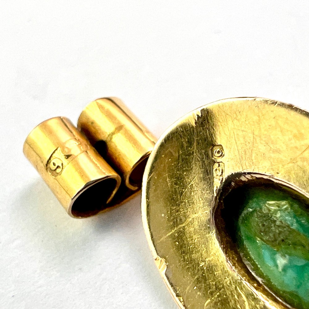 A pair of Etruscan Revival drop earrings in yellow gold featuring oval cabochon turquoise stones with detailed ropework and granulation. View VI