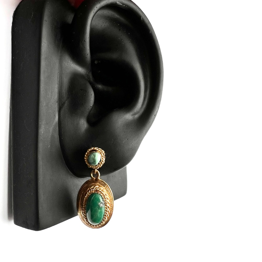 A pair of Etruscan Revival drop earrings in yellow gold featuring oval cabochon turquoise stones with detailed ropework and granulation. View IX