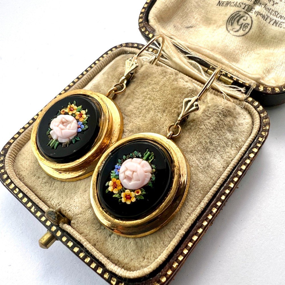 A pair of oval yellow gold drop earrings featuring micro mosaic floral designs with central pink roses on a black background. View II