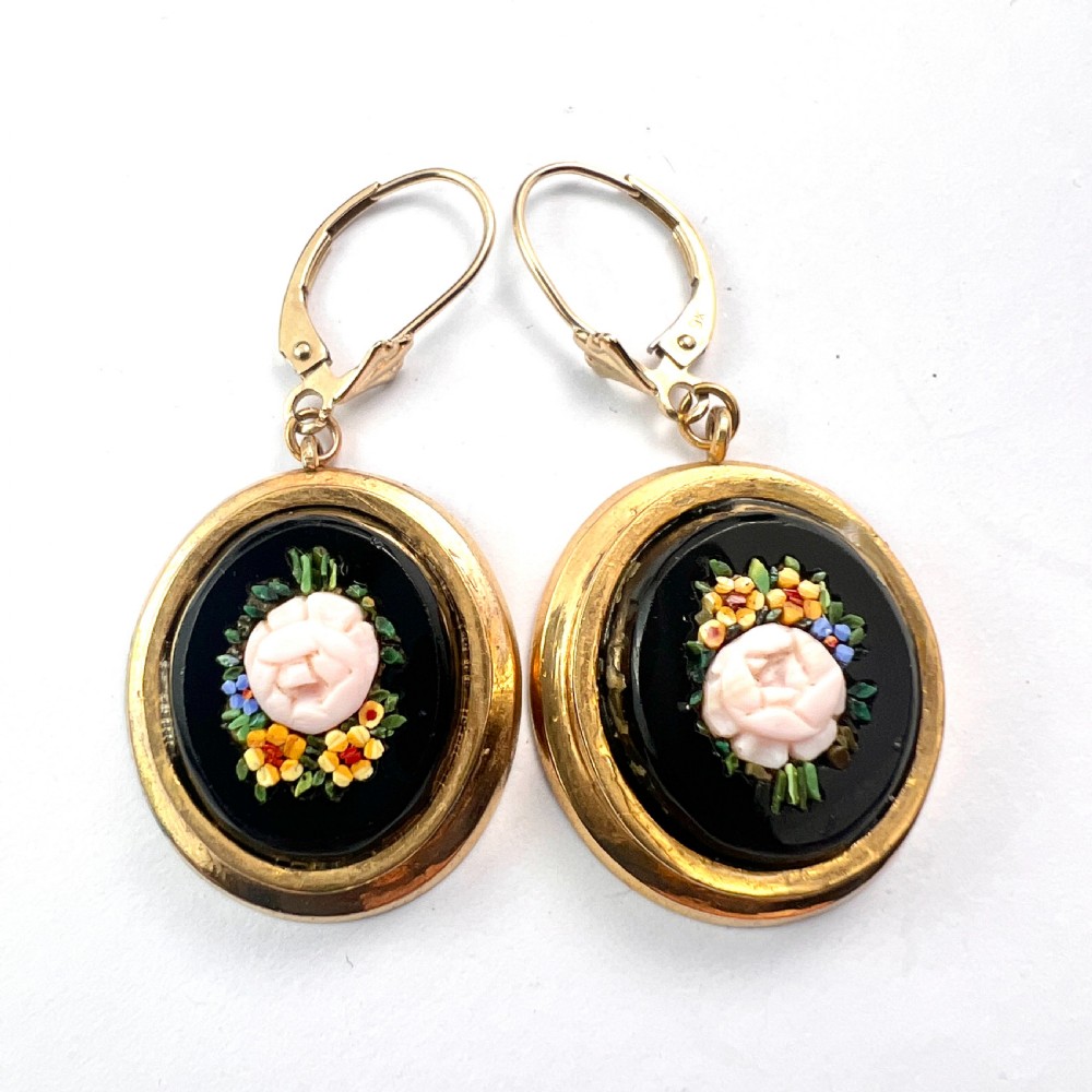 A pair of oval yellow gold drop earrings featuring micro mosaic floral designs with central pink roses on a black background. View IV