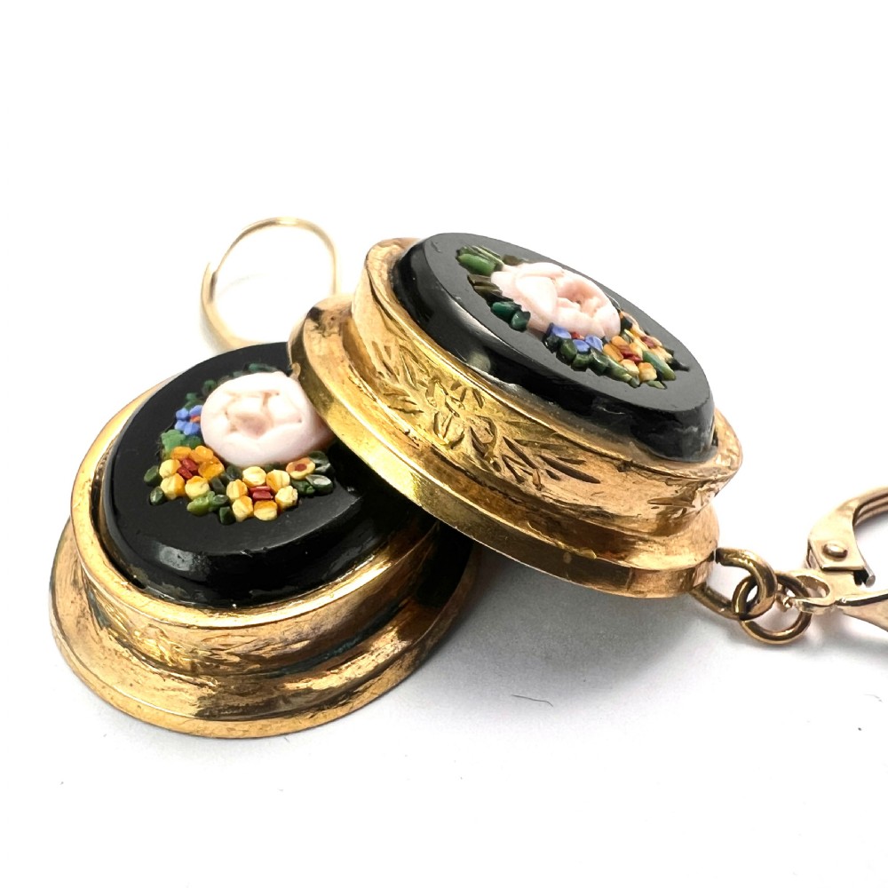 A pair of oval yellow gold drop earrings featuring micro mosaic floral designs with central pink roses on a black background. View VI