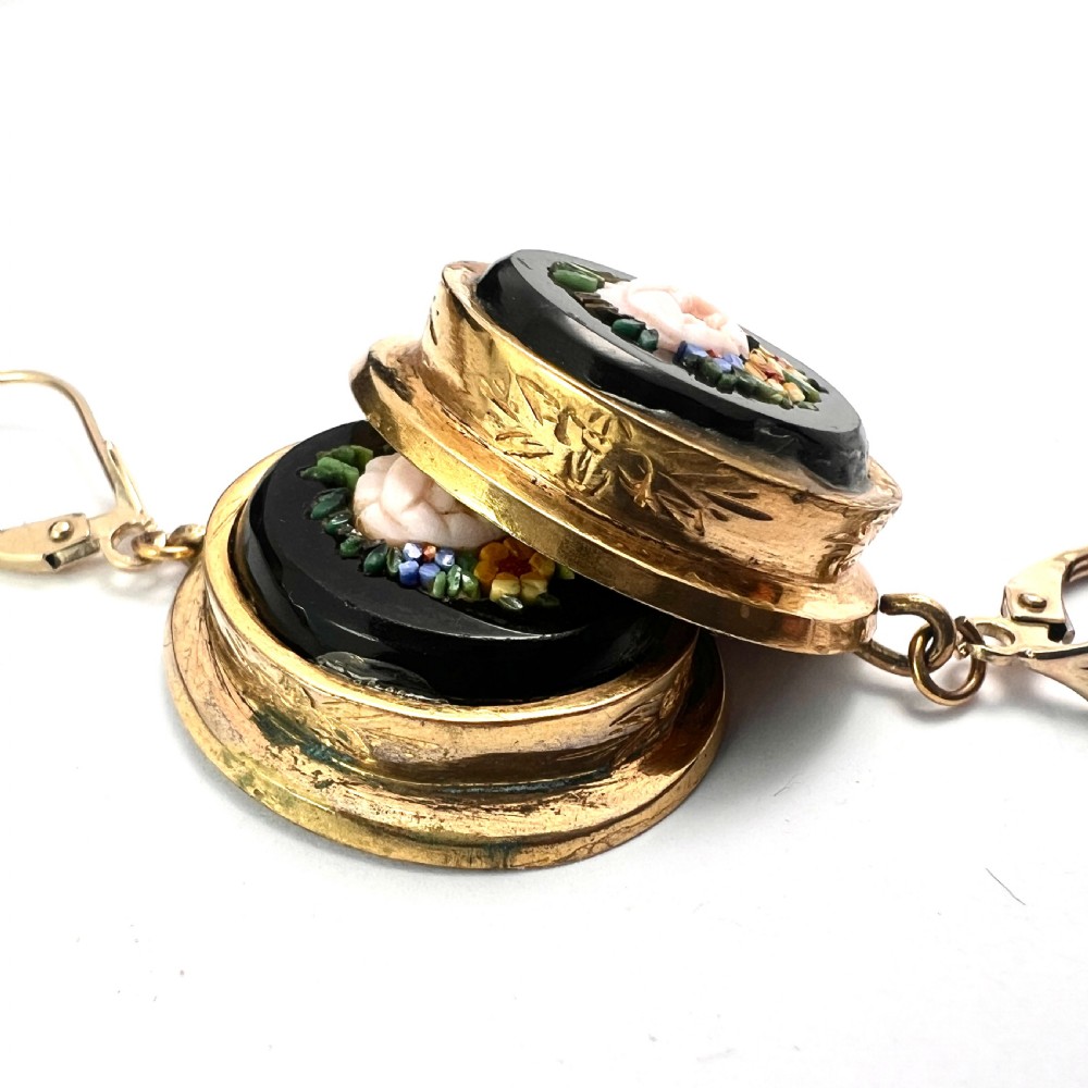 A pair of oval yellow gold drop earrings featuring micro mosaic floral designs with central pink roses on a black background. View VII