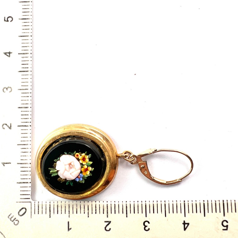 A pair of oval yellow gold drop earrings featuring micro mosaic floral designs with central pink roses on a black background. View X