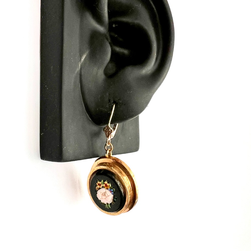 A pair of oval yellow gold drop earrings featuring micro mosaic floral designs with central pink roses on a black background. View XI