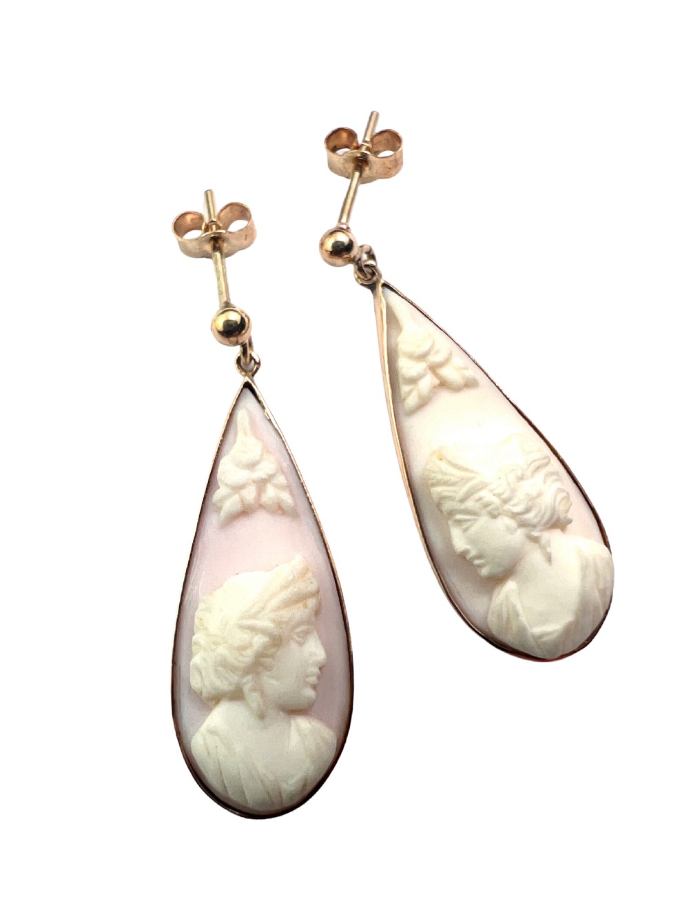 A pair of teardrop-shaped 9ct gold drop earrings featuring carved shell cameos with classical profile portraits set against a pink shell background. View II