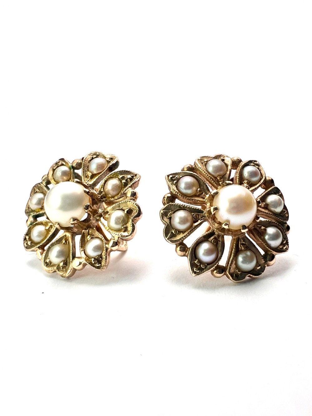 A pair of Victorian 9ct gold earrings featuring a central pearl surrounded by eight smaller seed pearls arranged in a floral cluster pattern. View IV
