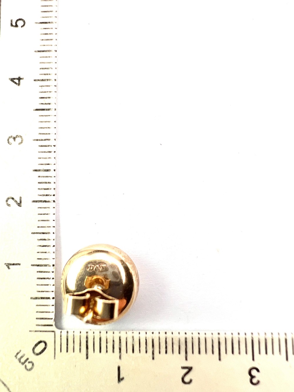 A pair of circular domed yellow gold stud earrings featuring hand-engraved scrollwork across the surface. View IV