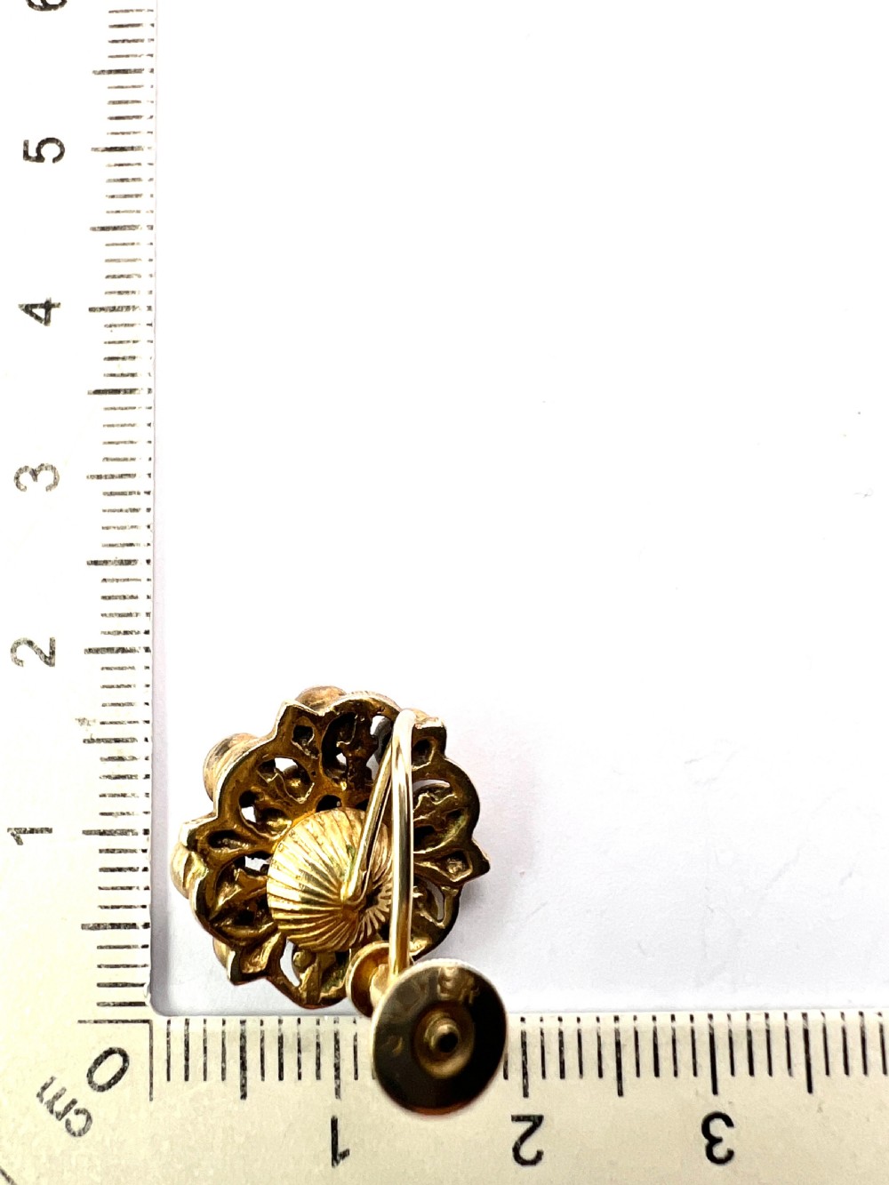 A pair of antique silver-gilt earrings set with deep red cabochon garnets arranged in a circular cluster halo design. View VIII