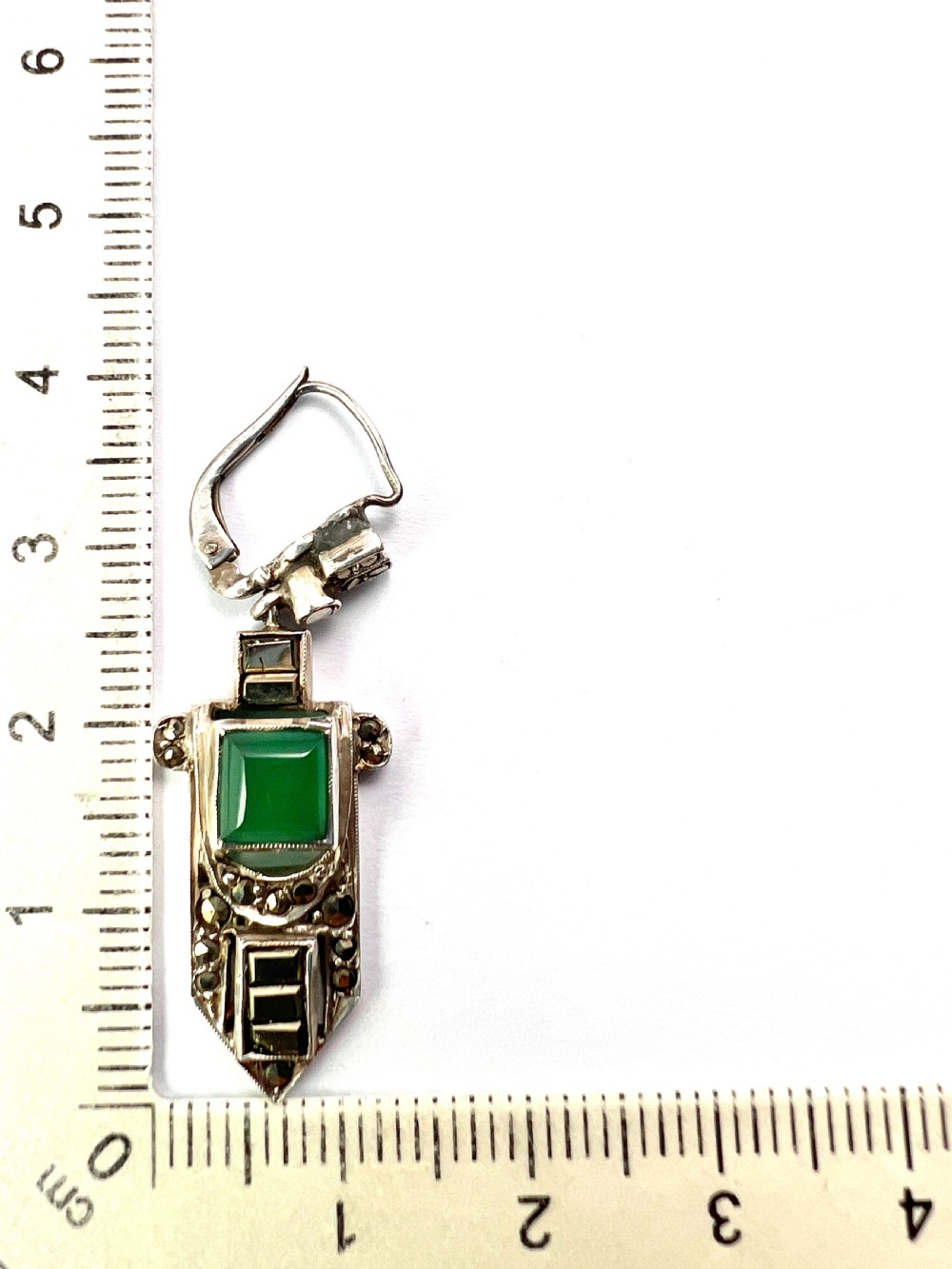 A pair of silver Art Deco drop earrings featuring square green chrysoprase cabochons within geometric stepped frames set with marcasite stones. View VI