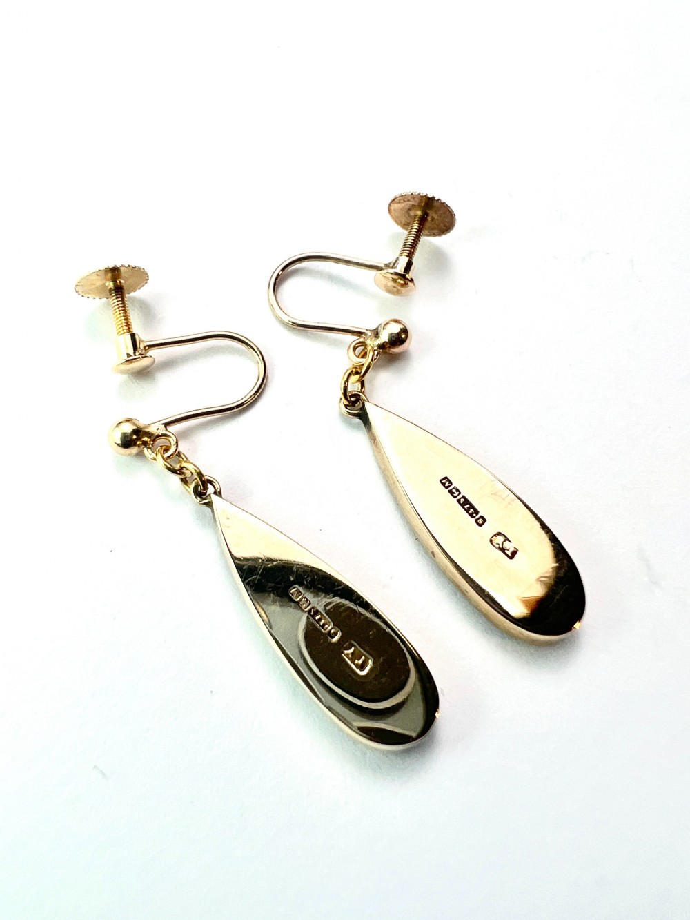 A pair of vintage 9ct yellow gold drop earrings featuring elongated black onyx teardrops suspended from screw-back fittings. View III