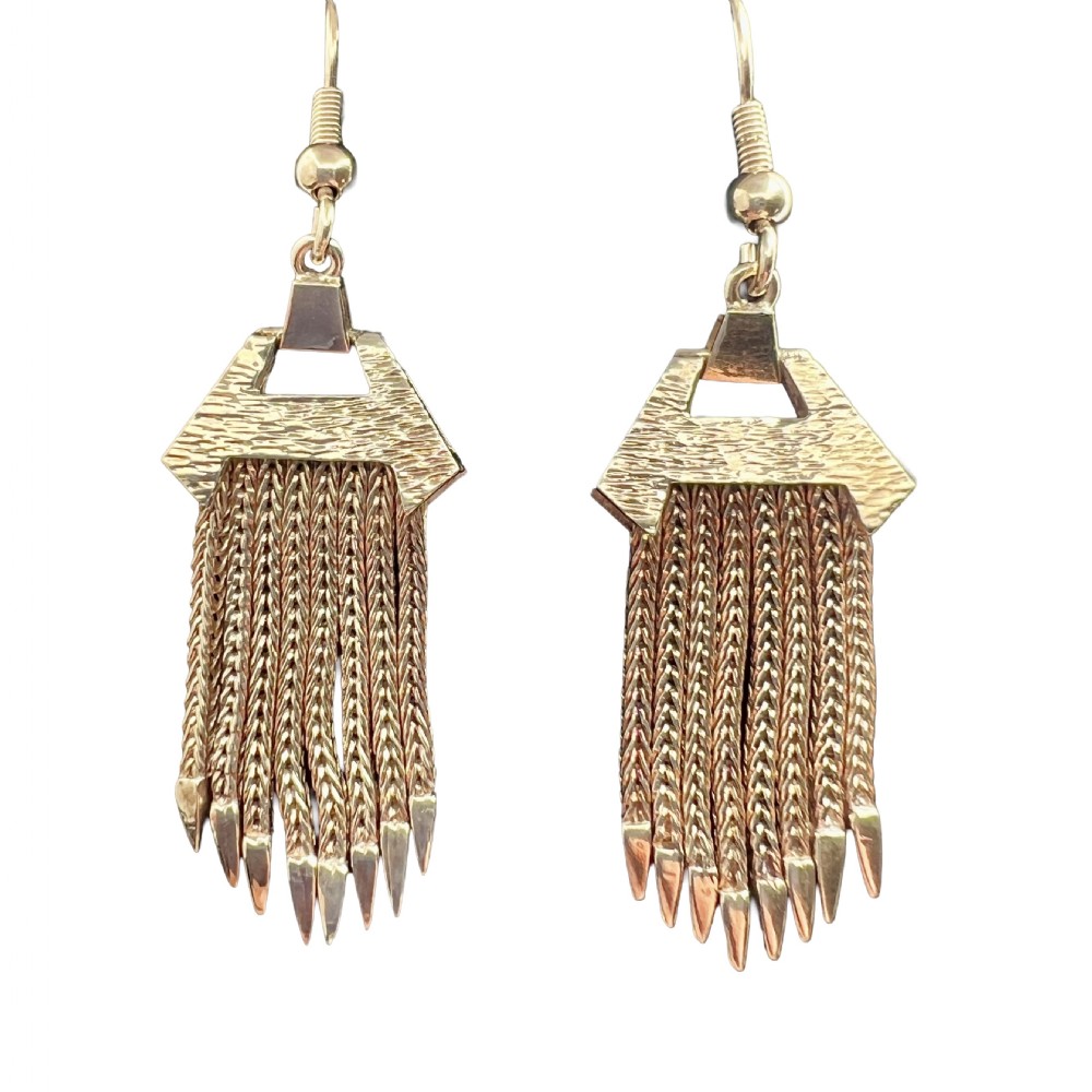 A pair of vintage 9ct gold drop earrings featuring textured geometric caps suspending multiple foxtail chain tassels with pointed tips.