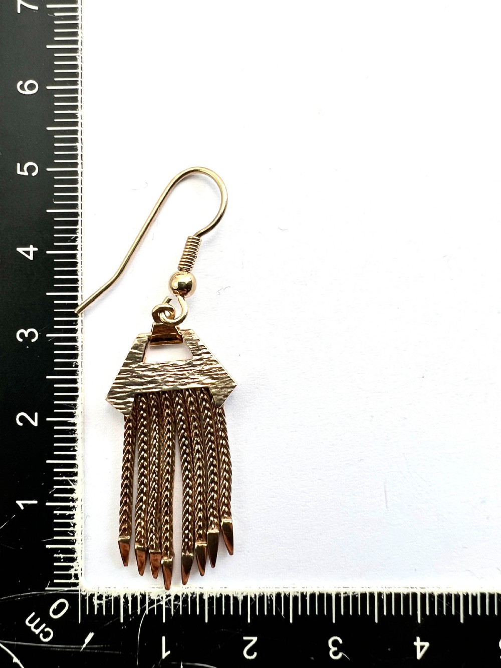 A pair of vintage 9ct gold drop earrings featuring textured geometric caps suspending multiple foxtail chain tassels with pointed tips. View VI