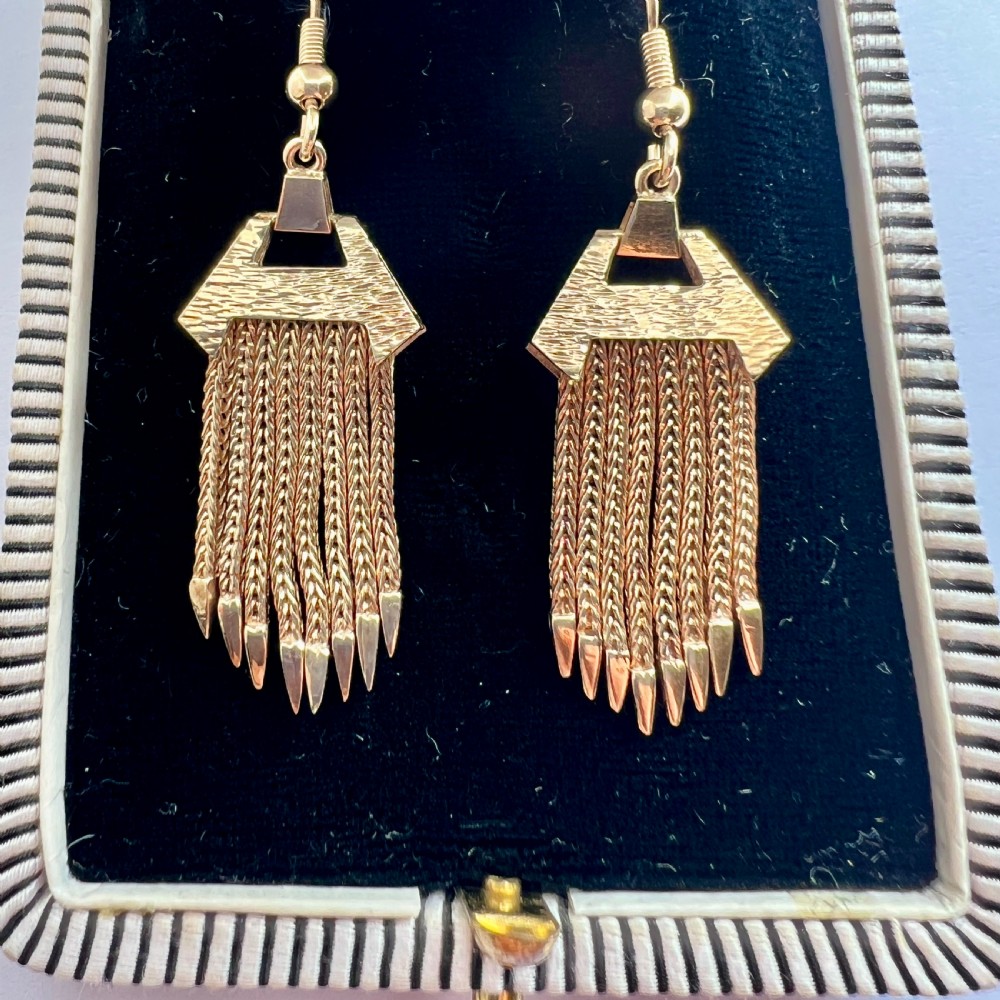 A pair of vintage 9ct gold drop earrings featuring textured geometric caps suspending multiple foxtail chain tassels with pointed tips. View VII