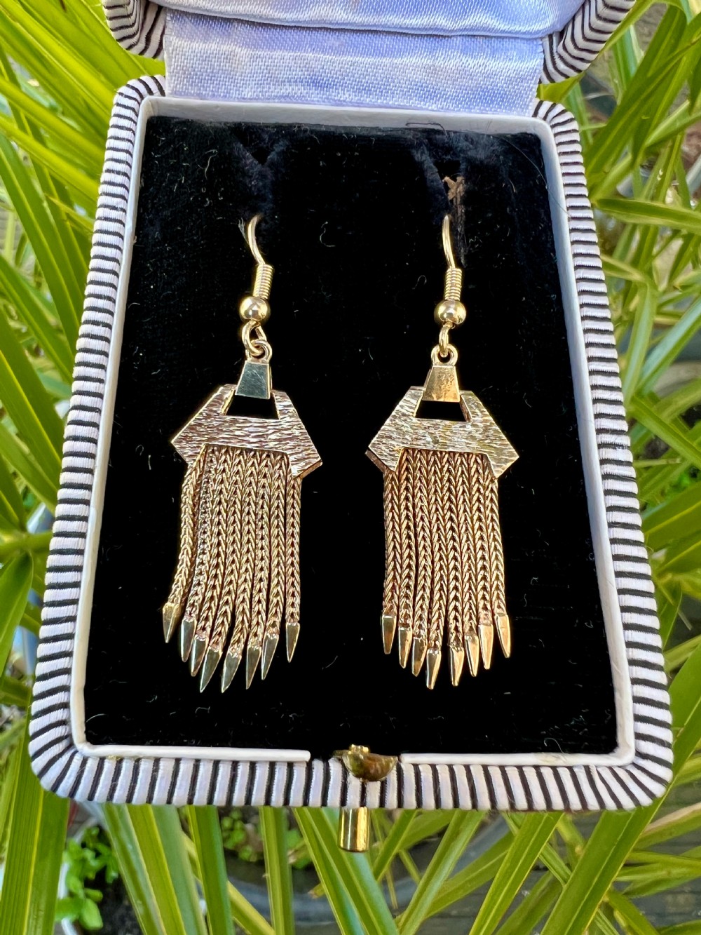 A pair of vintage 9ct gold drop earrings featuring textured geometric caps suspending multiple foxtail chain tassels with pointed tips. View IX
