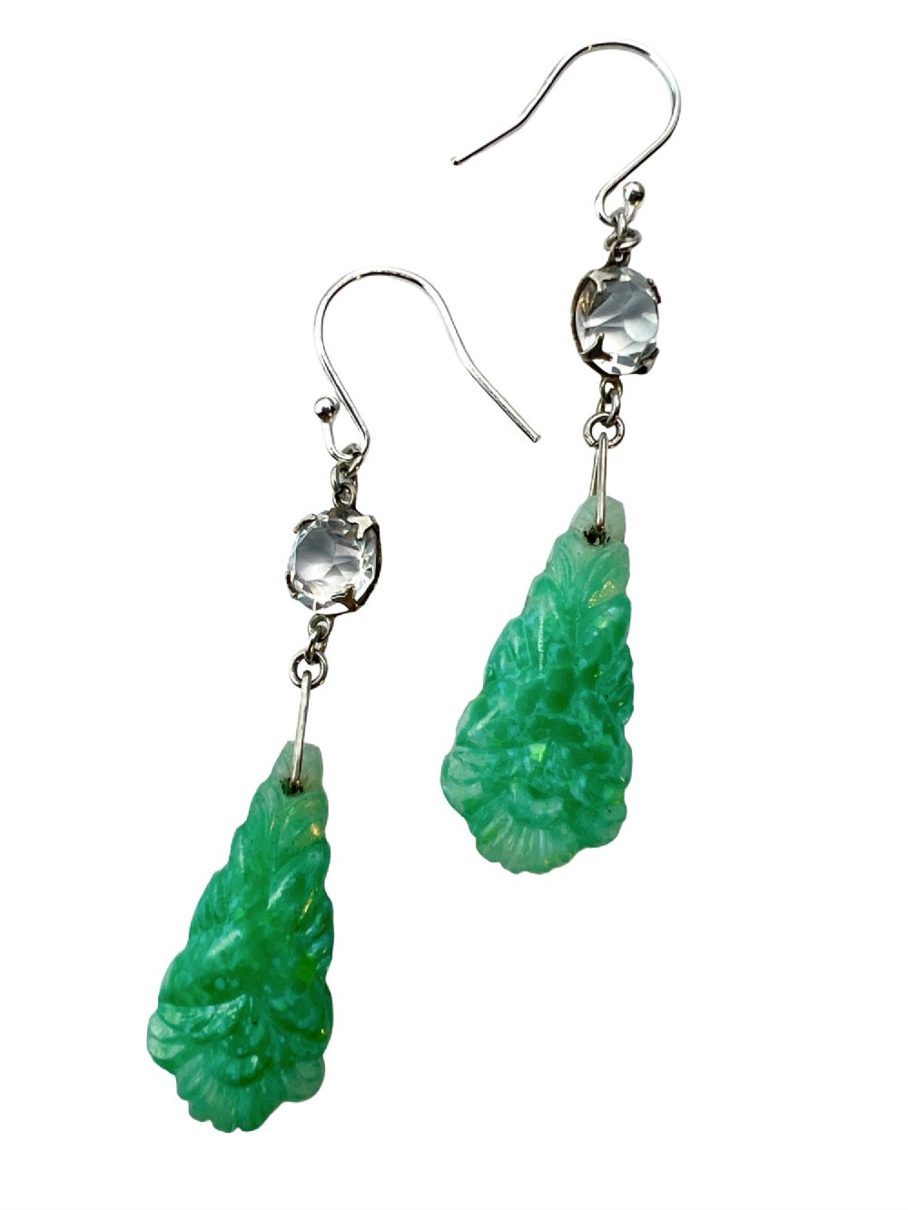 A pair of silver drop earrings featuring clear round crystals above carved green glass teardrop pendants. View IV
